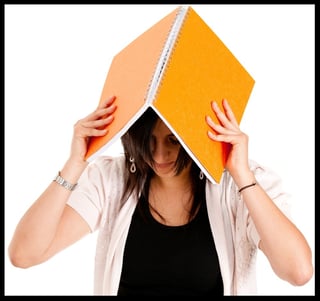 Frustrated female student holding a book isolated-275000-edited.jpeg