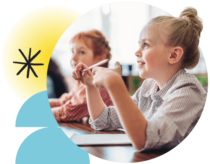 Young girl smiling in classroom with pencil in hand