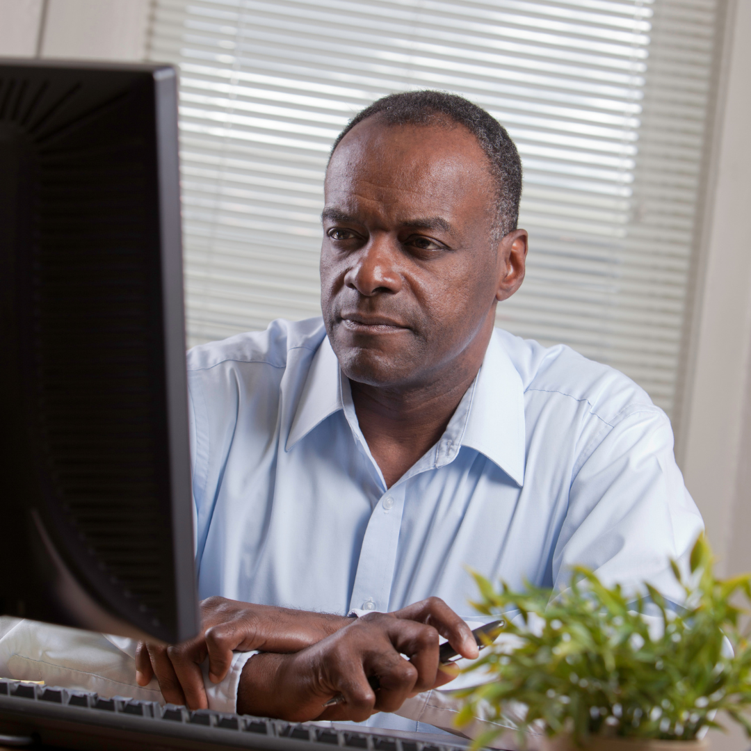 picture of man looking at computer screen