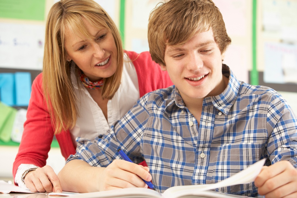 coach working with student on homework